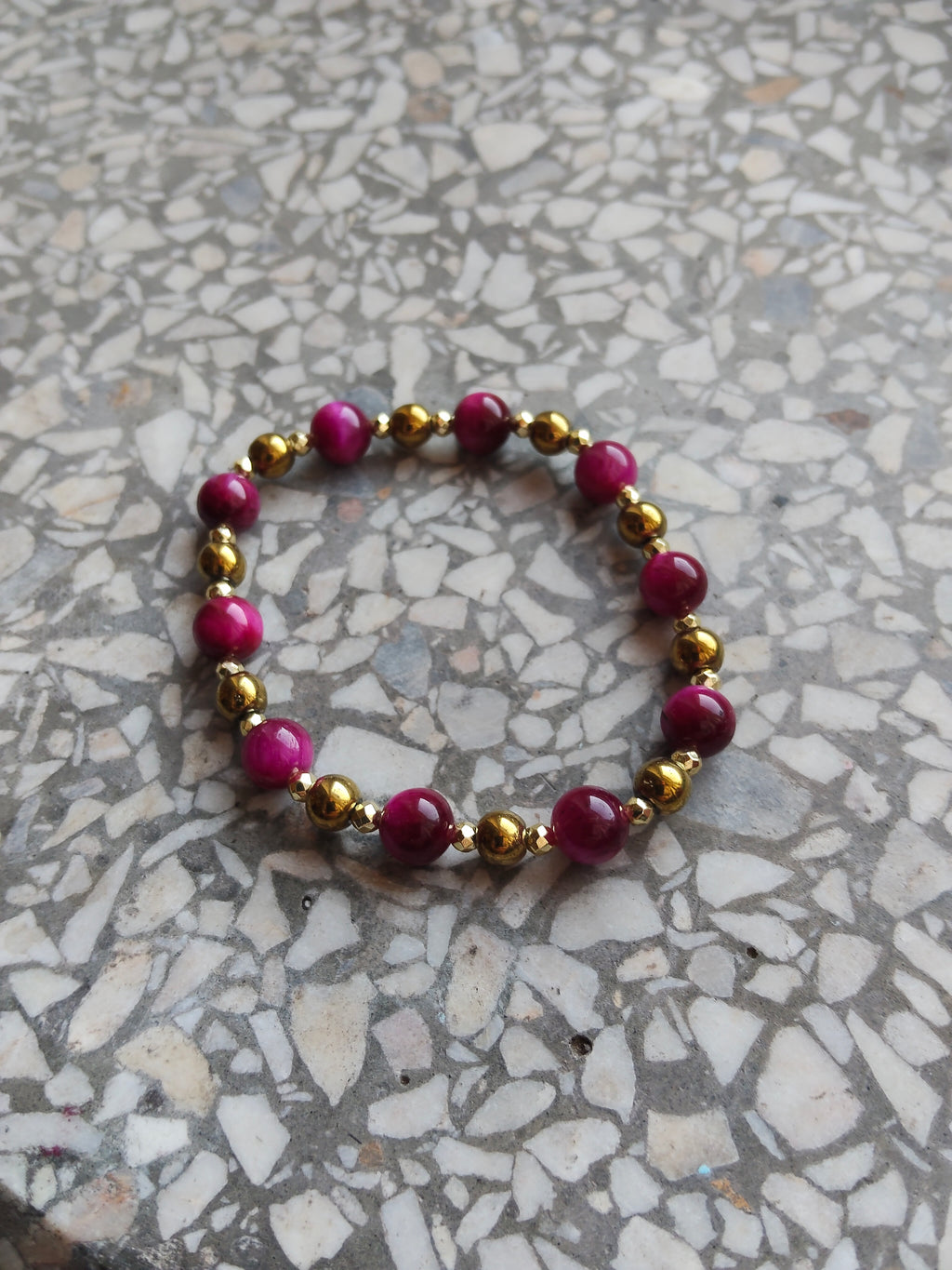 A genuine crystal bracelet pink-dyed tiger's eye and hematite golden minerals sizes your lucky charm